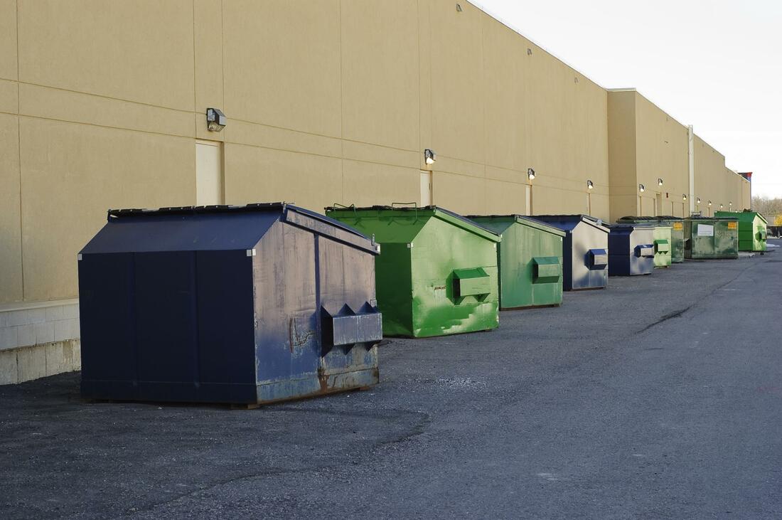 A long line of commercial dumpsters outside of a department store in Syracuse, NY